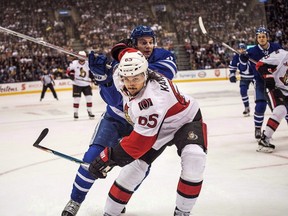 Ottawa Senators defenceman Erik Karlsson fends off Toronto Maple Leafs centre Zach Hyman during an NHL game on Feb. 18 2017. (THE CANADIAN PRESS/Aaron Vincent Elkaim)