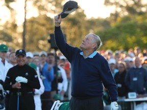 Jack Nicklaus tips his hat skyward in honour of the late Arnold Palmer as Gary Player looks on in Augusta, Ga., yesterday. (AP)