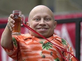 Actor Verne Troyer, aka Mini Me, toasts with a 'mini-mug' of beer after leading the worlds largest Chicken Dance and Kazoo band at Oktoberfest-Zinzinnati September 22, 2002 in Cincinnati, Ohio. (Photo by Mike Simons/Getty Images)