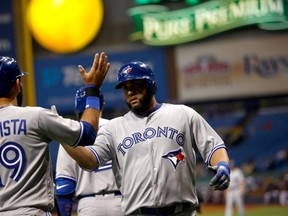 Kendrys Morales of the Toronto Blue Jays celebrates at home plate with teammate Jose Bautista after hitting a grand slam off of pitcher Blake Snell of the Tampa Bay Rays during a MLB game on April 6, 2017 at Tropicana Field. (Brian Blanco/Getty Images)