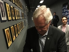 Maple Leafs legend Darryl Sittler autographs a jersey during Thursday night's game between the Leafs and Tampa Bay Lightning at the ACC. (JOE WARMINGTON/TORONTO SUN)
