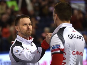 Canadian skip Brad Gushue and Brett Gallant congratulate each other after defeating Norway 8-4 Thursday night at the curling world championships in Edmonton.  (Ed Kaiser/Postmedia Network)