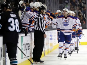 Edmonton Oilers' Connor McDavid, center, celebrates his goal against the San Jose Sharks during the second period of an NHL hockey game Thursday, April 6, 2017, in San Jose, Calif.