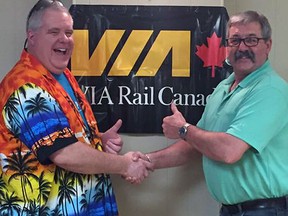 Submitted photo: Wallaceburg Splash Pad organizer Chris Young, presents a pair of VIA Rail passes to Gus Lalonde during the Splash Pad's trivia night fundraiser held on April 1 at the CBD Club. The event was a big fundraiser for the organization, as over $8,000 was raised for the splash pad, which will be constructed on Running Creek Drive on the former Colwell Pool property.
