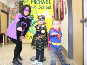 BRUCE BELL/THE INTELLIGENCER
St. Michael Catholic School Super Principal (Michele McGrath) is joined by Batwoman (Addison Tokley) and Superman (Liam McCoy) from the kindergarten class during Superhero Day at the school. Students particpated in buy-in activities all week to support Ronald McDonald House in Toronto.