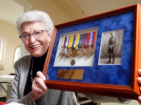 Luke Hendry/The Intelligencer
Anne Davis holds a frame containing the medals, a pin and a photo belonging to her late father, Capt. Jack Haydon, Wednesday in her apartment in Belleville. Haydon served in the First World War and Davis is now in Ottawa to attend ceremonies marking the 100th anniversary of the Battle of Vimy Ridge.