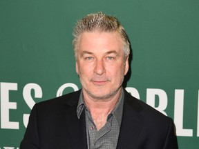 Actor Alec Baldwin holds a copy of his new book 'Nevertheless: A Memoir' before his book signing at Barnes & Noble Union Square in New York on April 4, 2017. / AFP PHOTO / ANGELA WEISSANGELA WEISS
