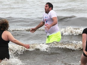 Jason Lithgow reacts after entering Lake Huron at Ipperwash Beach last year for the inaugural Cold Water Dip to Help Someone in Need. The second annual event is Saturday. (file photo)