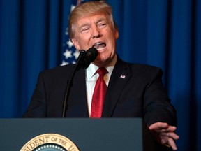 US President Donald Trump delivers a statement on Syria from the Mar-a-Lago estate in West Palm Beach, Florida, on April 6, 2017. Trump ordered a massive military strike against a Syria Thursday in retaliation for a chemical weapons attack they blame on President Bashar al-Assad. A US official said 59 precision guided missiles hit Shayrat Airfield in Syria, where Washington believes Tuesday's deadly attack was launched. (JIM WATSON/AFP/Getty Images)