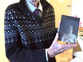 Bob Sutherland holds a photo of his father, Angus, who was wounded during the Battle of Vimy Ridge on April 9, 1917. Sutherland is in Ottawa this weekend to participate in events commemorating the 100th anniversary of the Battle of Vimy Ridge, including a ceremony Sunday morning at the National War Memorial. Mike Norris/The Whig-Standard/Postmedia Network