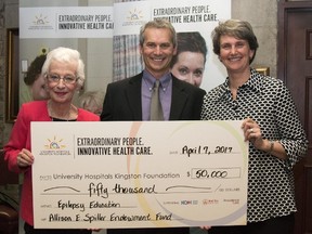 The late Dr. Allison Spiller's mother, Linda Payne, from left, brother, Grant Spiller, and spous, Suzy Lister, hold up a $50,000 cheque at Hotel Dieu Hospital in Kingston at the endowment fund announcement in her honour. The $50,000 was raised for the Allison E. Spiller Epilepsy Education Endowment Fund, which will support epilepsy education in Kingston. (Taylor Bertelink/For The Whig Standard/Postmedia Network)