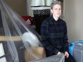 Courtney Milner sits with some items that were able to be protected after flooding in her parents’ basement on Lakeshore Boulevard. Steph Crosier, Kingston Whig-Standard, Postmedia Network