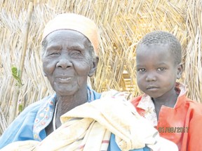 Mary Akot, a widow, walked for two days with her grandson Garang to ask for help. (Photo by Carol Campbell)