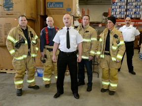 Firefighters Scott Young, Capt. Gary Martin, deputy Chief Dave Lazenby, Paul Schlinderer, Tina Sirka and St John Ambulance operations manager Jeff Lavigne take part in Friday?s launch of the London Food Bank?s 30th Spring Food Drive. (MORRIS LAMONT, The London Free Press)