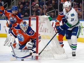 Edmonton Oilers goalie Cam Talbot makes a save against the Vancouver Canucks' Henrik Sedin at Rogers Place in Edmonton on March 18, 2017. The Oilers won 2-0. (David Bloom)
