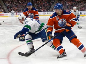 The Edmonton Oilers' Jordan Eberle (14) battles the Vancouver Canucks' Sven Baertschi (47) at Rogers Place, in Edmonton on March 18, 2017. David Bloom)
