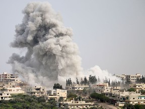Smoke billows following a reported airstrike on a rebel-held area in the southern Syrian city of Daraa, on April 8, 2017. (MOHAMAD ABAZEED/AFP/Getty Images)