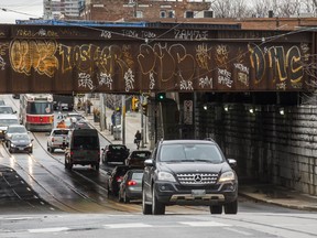 Graffiti can be seen along the rail overpass at Queen St. W. and Dufferin St. in Toronto. The rail overpass is on Metrolinx property. (ERNEST DOROSZUK/TORONTO SUN)