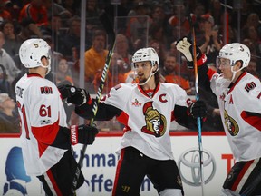 Mark Stone, Erik Karlsson and Kyle Turris of the Ottawa Senators celebrate a first-period goal by Karlsson against the Philadelphia Flyers at the Wells Fargo Center on March 28, 2017. (Bruce Bennett/Getty Images)