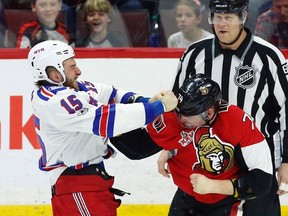 Ottawa Senators' Mark Borowiecki fights with New York Rangers' Tanner Glass during first period NHL hockey action in Ottawa on April 8, 2017. (THE CANADIAN PRESS/Fred Chartrand)