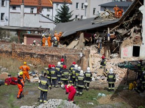 Rescuers and firefighters search for 11 missing people in the rubble of an apartment house that collapsed in Swiebodzice, Poland, on Saturday, April 8, 2017. Firefighters suspect the collapse might have been caused by a gas explosion. Several people were killed and injured. (AP Photo)