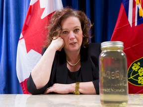 MPP Lisa MacLeod with a bottle of discoloured water from Lynnwood Gardens.