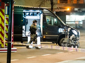 An officer works the scene as police cordon off a large area around a subway station on a busy commercial street Saturday night, April 8, 2017, after finding what they described as a "bomb-like" device, in Oslo, Norway. The official police Twitter account said one man has been arrested and Police Chief Vidar Pedersen said police were working to disarm it. (Fredrik Varfjell /NTB scanpix via AP)