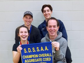 Ben Ashley, Owen Coles, Amelina Iturregui, and head coach Richard Breault with their team overall points banner they won at Saturday's badminton city finals at St. Benedict Secondary School. Keith Dempsey/For The Sudbury Star/Postmedia Network