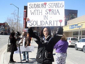 Elizabeth Sorrell holds a sign during a picket organized by the Ad Hoc Committee to Found the Sudbury Peace Council in Sudbury on Saturday. Ben Leeson/The Sudbury Star/Postmedia Network