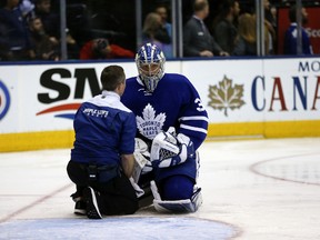 Toronto Maple Leafs goalie Frederik Andersen is looked after by a trainer during the second period of an NHL game against the Pittsburgh Penguins in Toronto on April 8, 2017. (Jack Boland/Toronto Sun/Postmedia Network)