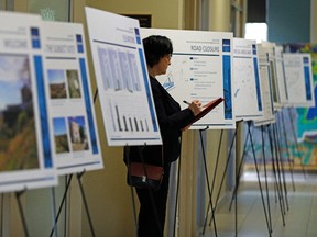 Cassandra Haraba collects information about a proposed 80-storey highrise building in downtown Edmonton at an information session held at the Boyle Street Community Centre on Saturday April 8, 2017. (PHOTO BY LARRY WONG/POSTMEDIA)