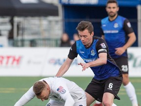 FC Edmonton midfielder Nik Ledgerwood battles with Jacksonville Armada  midfielder Jake Black falls at Clarke Park, in Edmonton April 8, 2017.