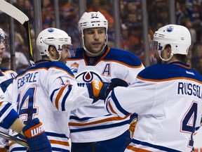 APRIL 8: Jordan Eberle #14 of the Edmonton Oilers celebrates with Milan Lucic #27 and Kris Russell #4 after scoring a goal against the Vancouver Canucks in NHL action on April 8, 2017 at Rogers Arena in Vancouver, British Columbia, Canada.
