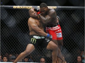 In this May 23, 2015, file photo, Daniel Cormier, left, and Anthony Johnson duel in the light heavyweight mixed martial arts title bout at UFC 187 on Las Vegas. (AP Photo/John Locher, File)