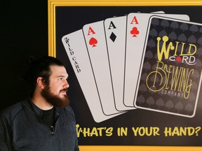 Nate Card, owner of Wild Card Brewing Company, stands by a sign in the front room of the brewery's Gotha Street location on Saturday April 8, 2017 in Quinte West, Ont. Wild Card will be just one of many local breweries participating in the craft beer festival, Hops On The Water. Tim Miller/Belleville Intelligencer/Postmedia Network