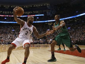 Toronto Raptors' P.J. Tucker saves a ball against Boston Celtics Al Horford during the second half in Toronto on Saturday Feb. 25, 2017. (Jack Boland/Toronto Sun/Postmedia Network)
