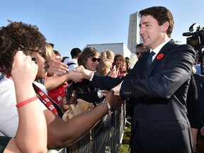 Prime Minister Justin Trudeau, right, shakes hands with people during a commemoration ceremony to mark the 100th anniversary of the Battle of Vimy Ridge at the Canadian National Vimy Memorial in Vimy, near Arras, northern France, on April 9, 2017. (PHILIPPE HUGUEN/AFP/Getty Images)