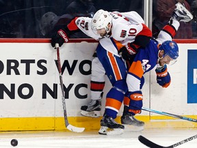 Ottawa Senators winger Tom Pyatt (10) battles for the puck with New York Islanders defenceman Calvin de Haan (44) Sunday, April 9, 2017, in New York. (AP Photo/Adam Hunger)