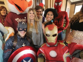 Tina Gould (centre) is attempting to raise money to purchase her child a dog that will provide medical aid. A fundraising event involving people dressed in costumes as part of Team Kyler took place in Winnipeg Saturday, April 8, 2017. (Winnipeg Sun/Postmedia Network)