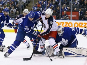 Roman Polak and Curtis McElhinney of the Maple Leafs scramble for a loose puck with Matt Calvert of the Colombus Blue Jackets during NHL action at the Air Canada Centre in Toronto on Sunday April 9, 2017. (Dave Abel/Toronto Sun/Postmedia Network)