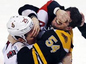 Ottawa Senators winger Chris Neil (25) and Boston Bruins defenceman Adam McQuaid (54) gouge each other’s eyes as they fight in Boston, Tuesday, Dec. 29, 2015. (AP Photo/Charles Krupa)