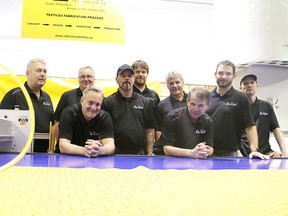 Advanced Textiles Technologies partners and employees pose for a photo beside the  Eastman Eagle 125 CNC fabric cutting table  on Thursday. ATT specializes in custom design, prototyping, and cut and sew fabrication. (Gino Donato/Sudbury Star)