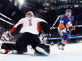 Islanders’ Connor Jones moves in on Senators goalie Mike Condon at the Barclays Center on Sunday. (Getty Images)