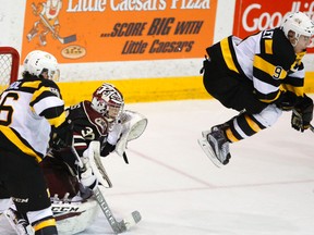 Kingston Frontenacs forward Nathan Dunkley tries to screen Peterborough Petes goalie Dylan Wells as Kingston's Ted Nichol stands in front of the net during Game 2 of an OHL Eastern Conference semifinal playoff series Sunday night in Peterborough. The Petes won the game 4-1. (Clifford Skarstedt/Postmedia Network)