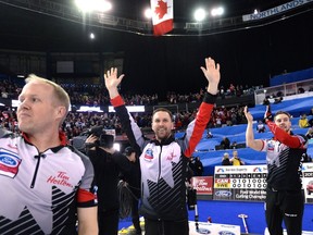 Canada third Mark Nichols, left, skip Brad Gushue and second Brett Gallant celebrate after defeating Sweden in the gold medal game at the Men's World Curling Championships in Edmonton, Sunday, April 9, 2017. (Jonathan Hayward/The Canadian Press)