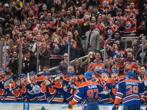 Leon Draisaitl (29) and Connor McDavid (97) of the Edmonton Oilers, celebrate McDavid's 100th point in their regular-season finale on the way to a 5-2 win over the Vancouver Canucks at Rogers Place on Sunday, April 9 2017. (Shaughn Butts)