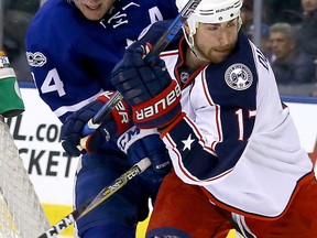 Leafs defenceman Morgan Rielly ties up Brandon Dubinsky of the Columbus Blue Jackets on Sunday night at the Air Canada Centre. (Dave Abel/Toronto Sun)