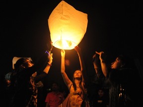 People launch a sky lantern.