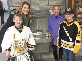 The Lucknow & District Kinette Club recently donated a new water fountain and water bottle fill station to the Lucknow & District Sports Complex. Pictured is Kinette president Breanne Chapman, Lucknow Novice Rep Goalie Brayden Curran and dedicated fans Jayden Maki and Annan Moffat.