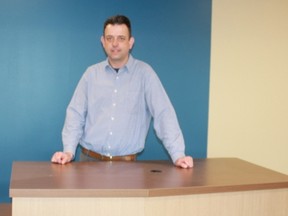 Brian Masschaele, director of community and cultural services for the County of Elgin, stands at the newly installed circulation desk at the Keystone Complex in Shedden. The new library will have a soft opening April 25. (Laura Broadley/Times-Journal)